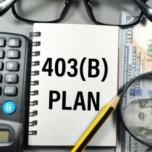 Business concept.Text 403 (B) PLAN with pencil,glasses,magnifying glass,banknote and calculator on gray background.